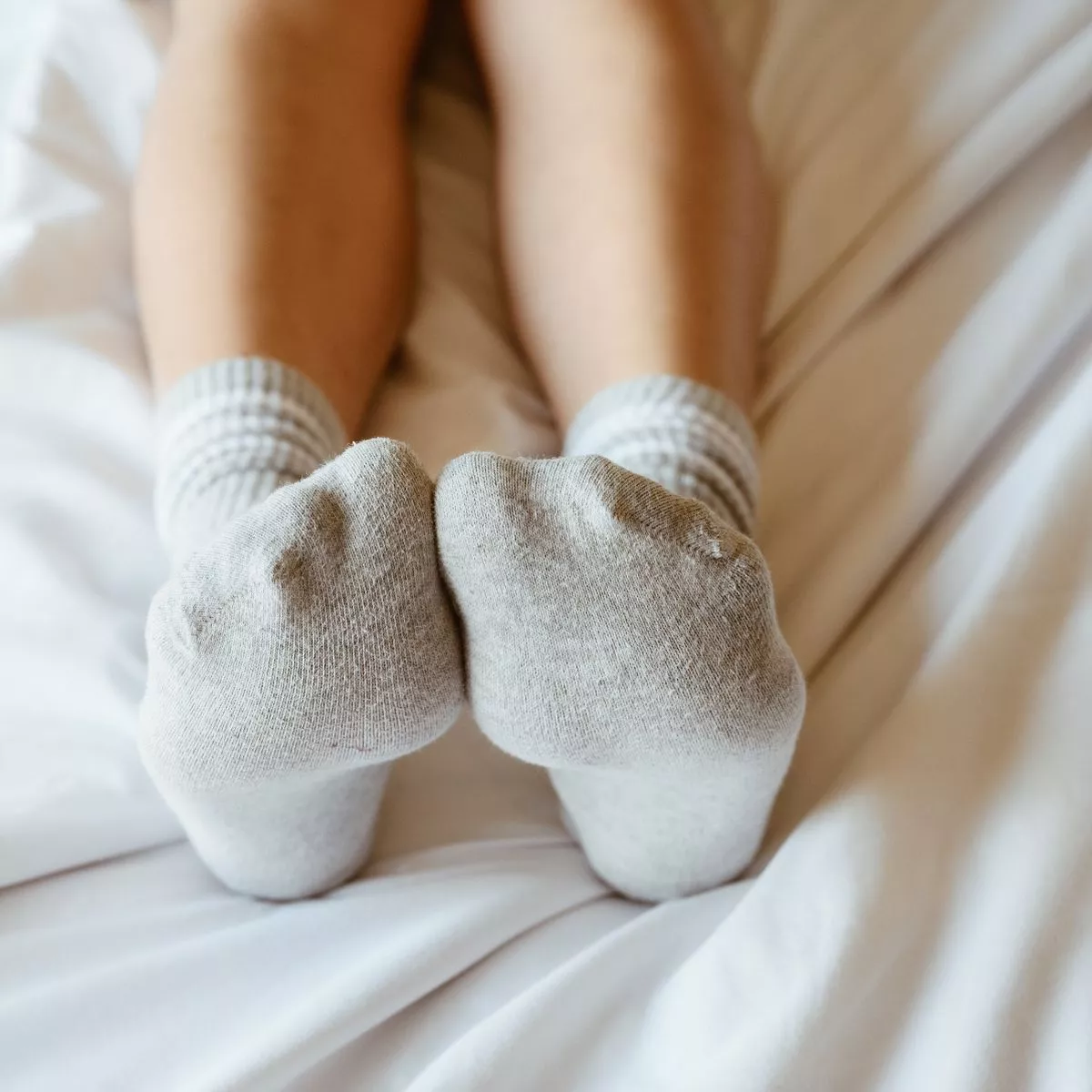 0 Cropped shot of women relaxing in bed with cozy socks