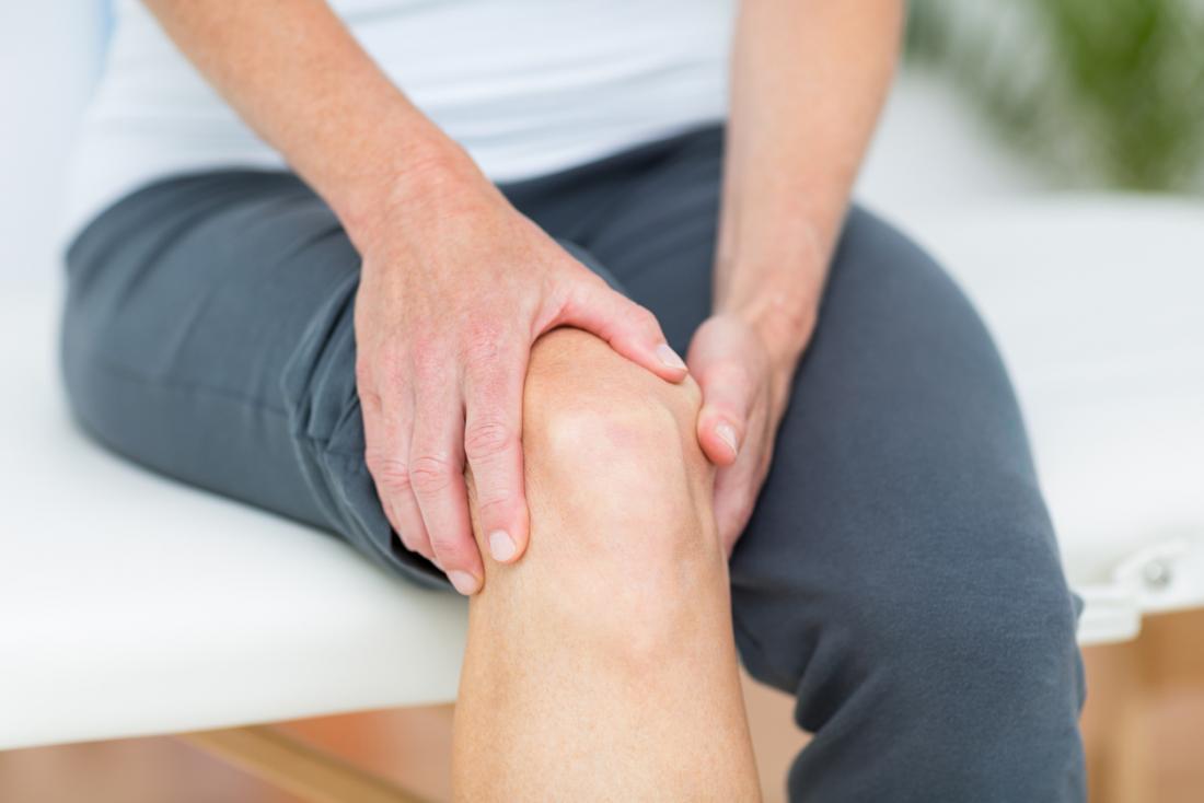 person experiencing joint pain in their knee