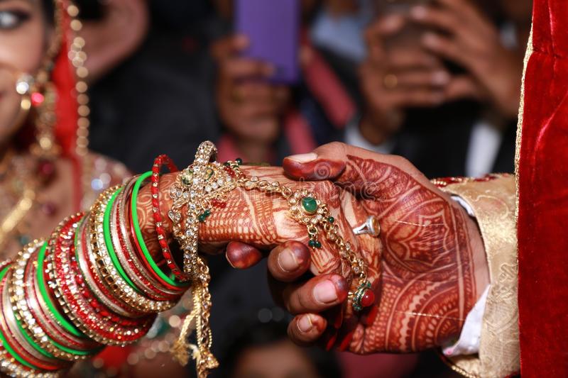 indian wedding couple holding hands 112562446